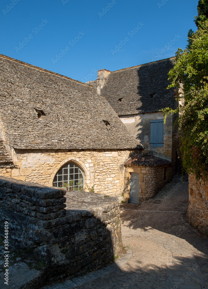  Typical French townscape with ancient housest and cobblestone street in the traditional town Beynac-et-Cazenac, France
