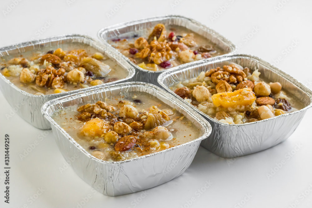 Fototapeta premium Traditional Dessert Asure,Noah's Pudding in foil container -take away package-at the white surface.
