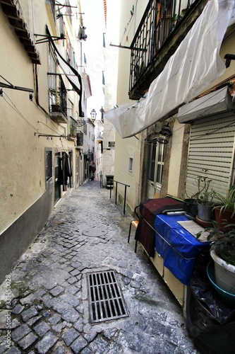 Narrow and colorful streets of Lisbon in a cloudy day photo