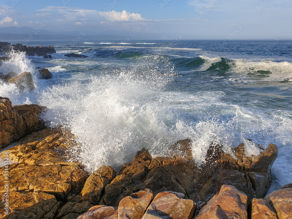 Turbulent sea crashing onto rocks.