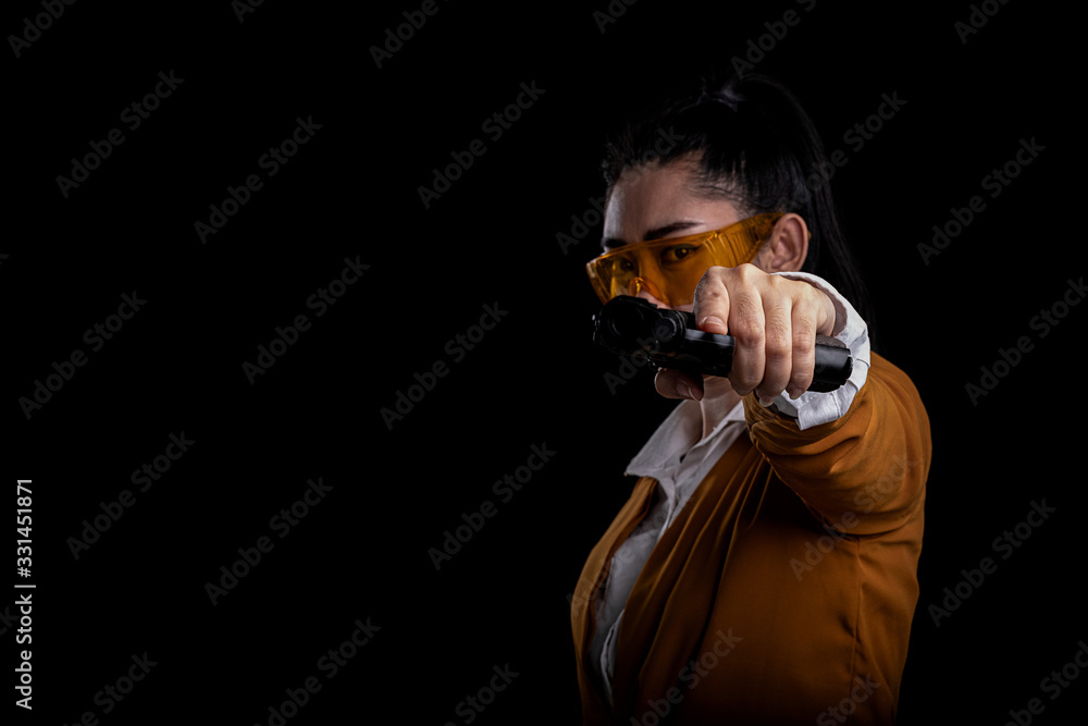 Women pointing a gun, Portrait beautiful asia woman wearing a yellow suit one hand holding pistol guns at the black background, Young sexy girl long hair with a handgun look at the camera Women pointing a gun, Portrait beautiful asia woman wearing a yellow suit one hand holding pistol guns at the black background, Young sexy girl long hair with a handgun look at the camera