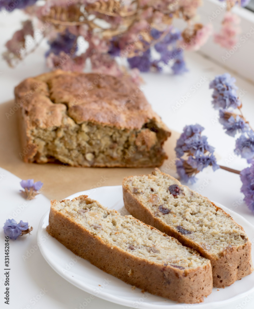 healthy homemade sugar pie on white background with flowers. Pie with raisins and nuts