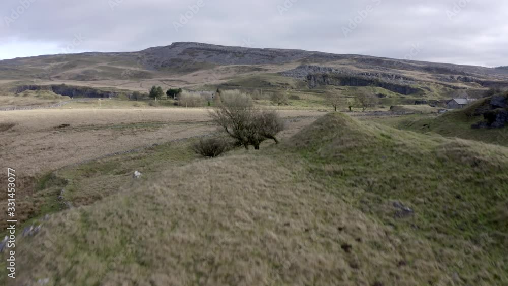 Drone shot clears ridge to reveal moorland landscape Drone shot clears ridge to reveal moorland landscape