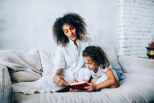Ethic woman reading book with child