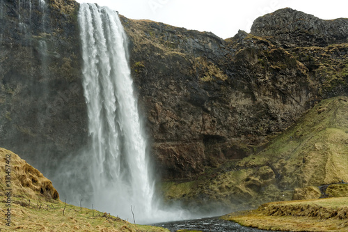 Seljalandsfoss waterfall under cloudy sky  Iceland