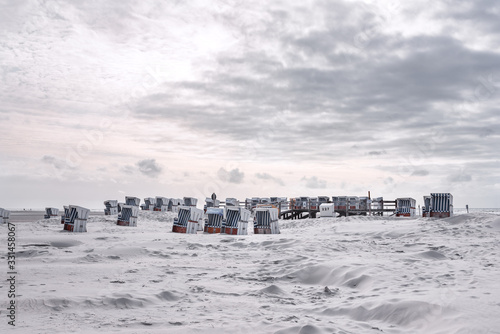 Canopied wicker beach chairs on the beach of St Peter-Ording photo