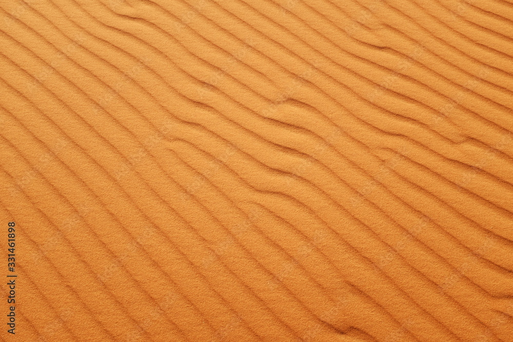 Bright orange desert sand ripples for hot summer background. Bright orange desert sand ripples for hot summer background.