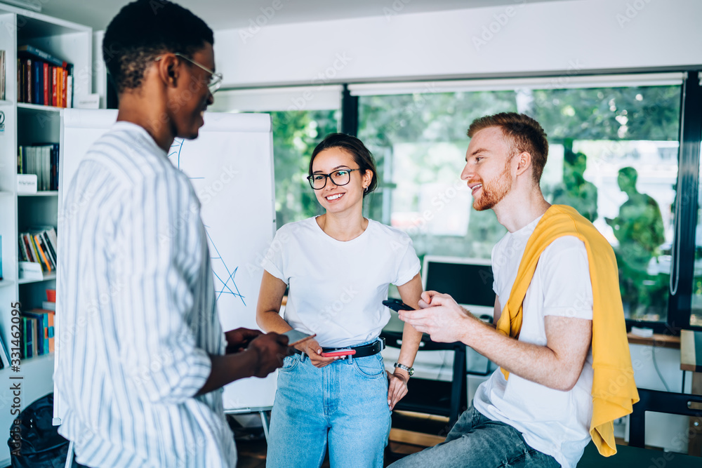 Fototapeta premium Smiling coworkers talking with each other