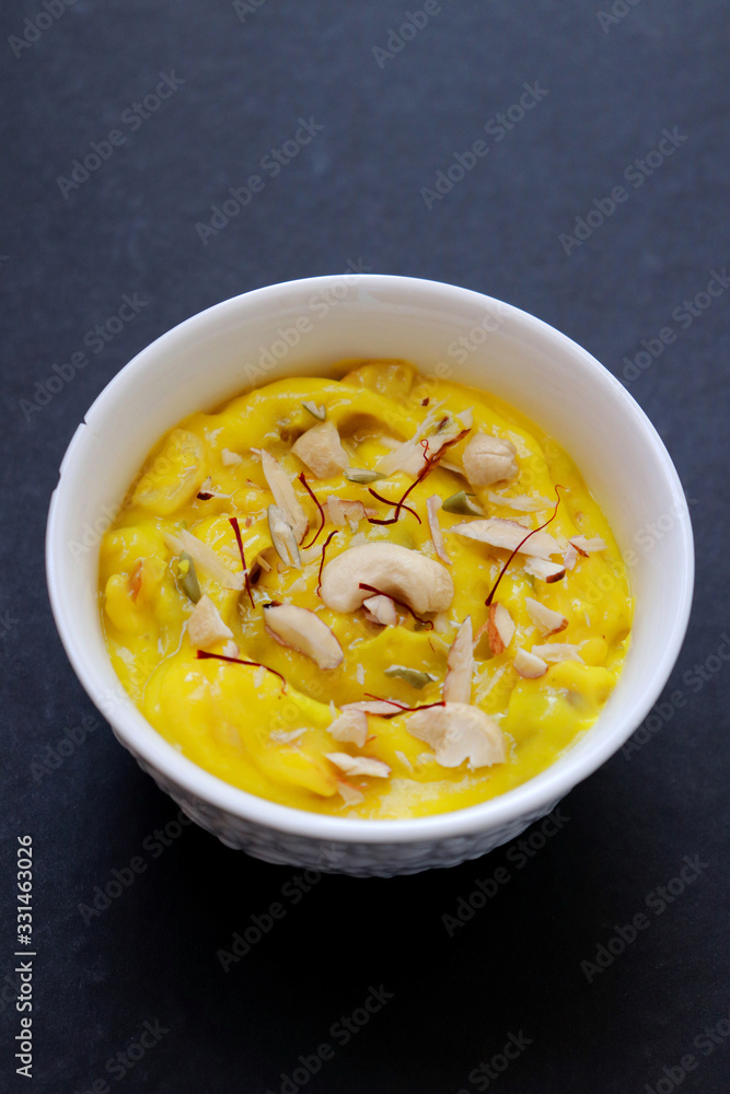 Indian dessert - Shrikhand or Srikhand is sweet yogurt dessert. Mostly eaten during Gudi Padwa festival with Puris. Garnished with dry fruits and saffron. Along with Happy Gudi Padwa message Greeting. Indian dessert - Shrikhand or Srikhand is sweet yogurt dessert. Mostly eaten during Gudi Padwa festival with Puris. Garnished with dry fruits and saffron. Along with Happy Gudi Padwa message Greeting.