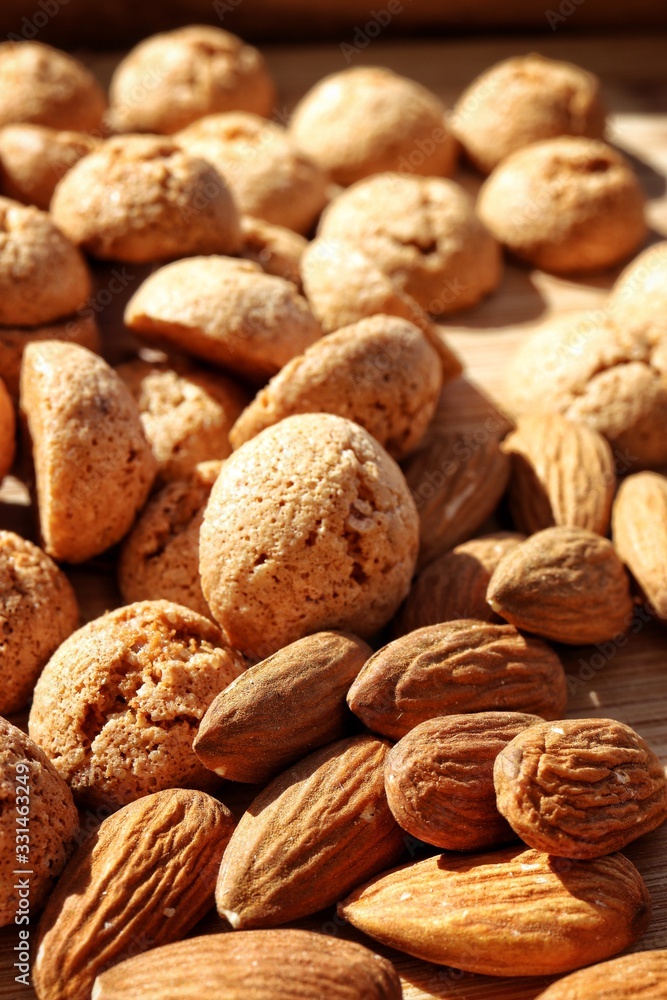Macro of almonds and amaretti cookies in the background. italian cantuccini cookies, sweet almond biscuits. Macro of almonds and amaretti cookies in the background. italian cantuccini cookies, sweet almond biscuits.