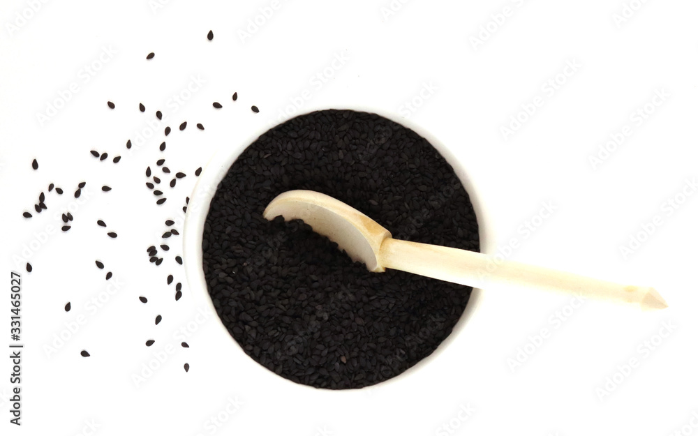 black seeds with a wooden spoon black seeds with a wooden spoon