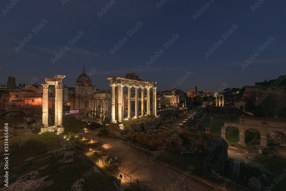Ruins of the Roman Forum at night in Rome, Italy