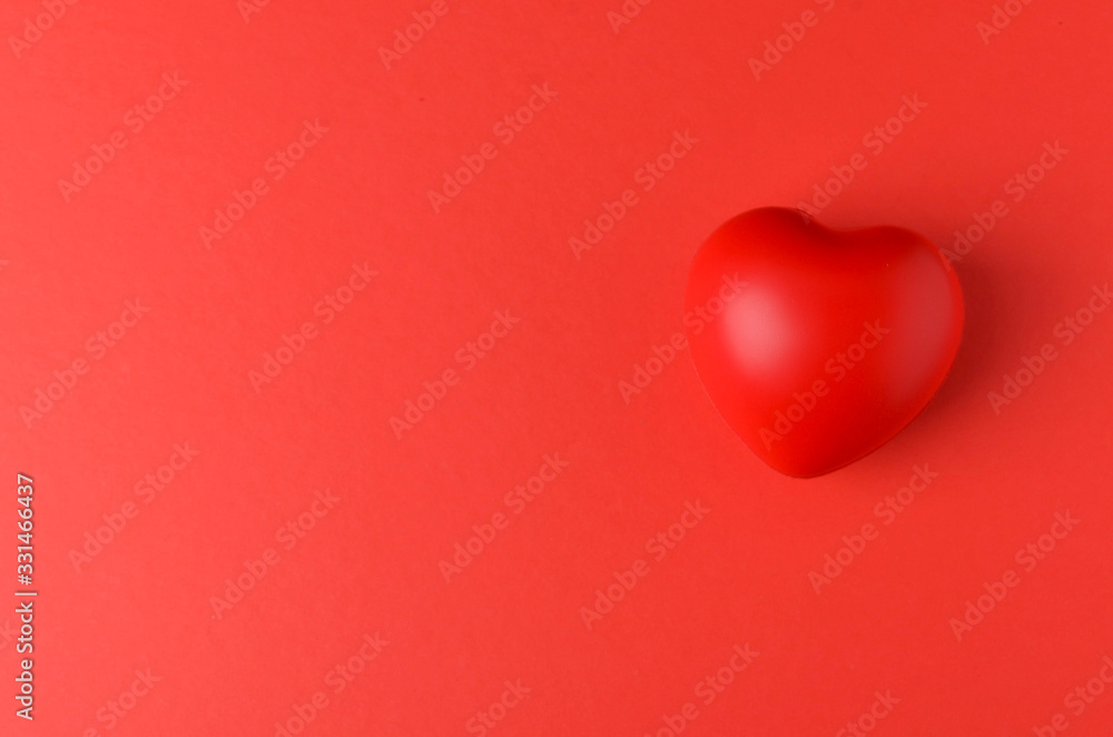 red heart on red background. Selective focus.