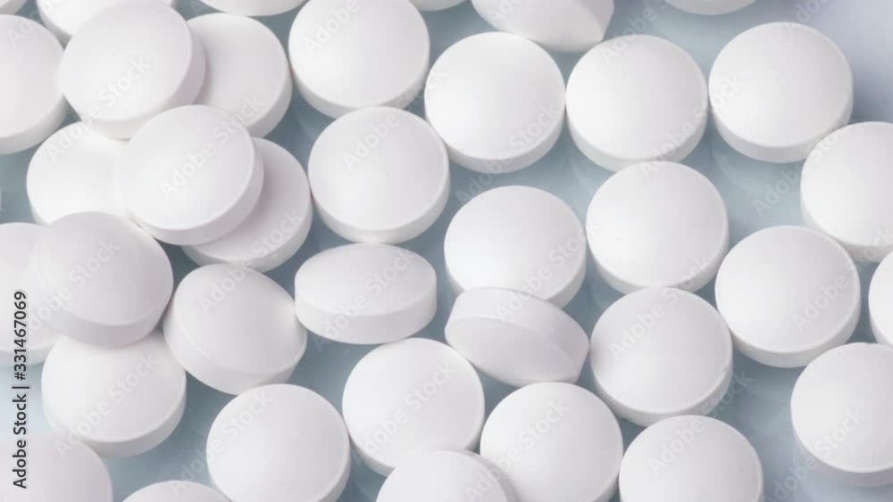 Closeup shot of different pills falling on table with tablets , pharmaceutical industry concept Closeup shot of different pills falling on table with tablets , pharmaceutical industry concept