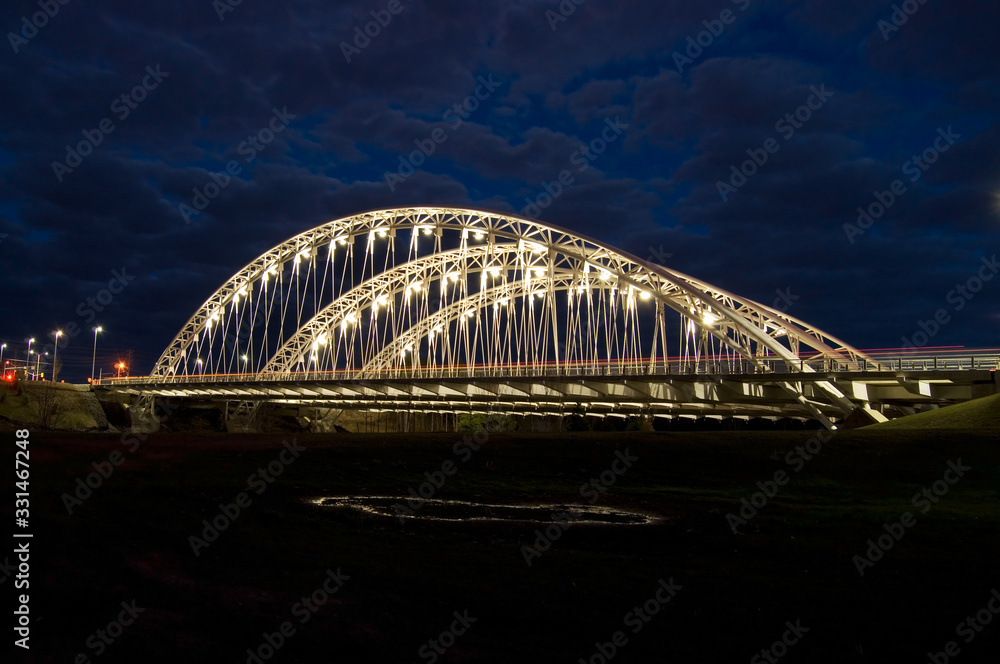Obraz premium Street View of Cars Crossing on the Vimy Memorial Bridge at Night
