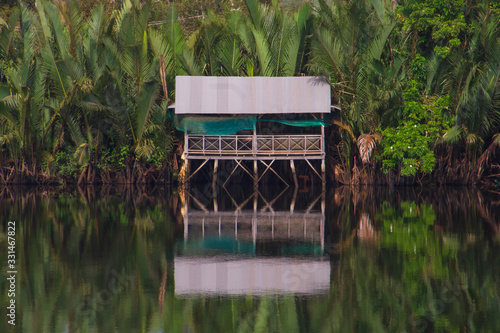 Wooden house boxe in the Cambodian jungle along the Preaek Tuek Chhuk River in Kampot. photo