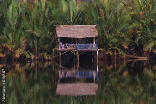 Wooden house boxe in the Cambodian jungle along the Preaek Tuek Chhuk River in Kampot. photo