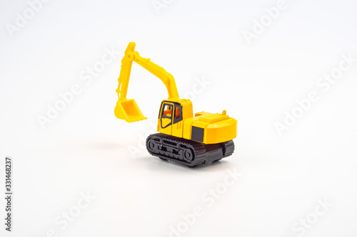 Yellow toy excavator isolated on white background.