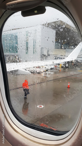 View from airplane window on rainy weather in airport.