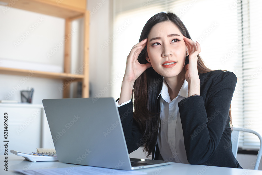 Asian woman office staff have headache, migraine while working. Healthy, Office syndrome, disease, illness, sick, muscle pain, overwork, neck ache, arthritis concept. Asian woman office staff have headache, migraine while working. Healthy, Office syndrome, disease, illness, sick, muscle pain, overwork, neck ache, arthritis concept.