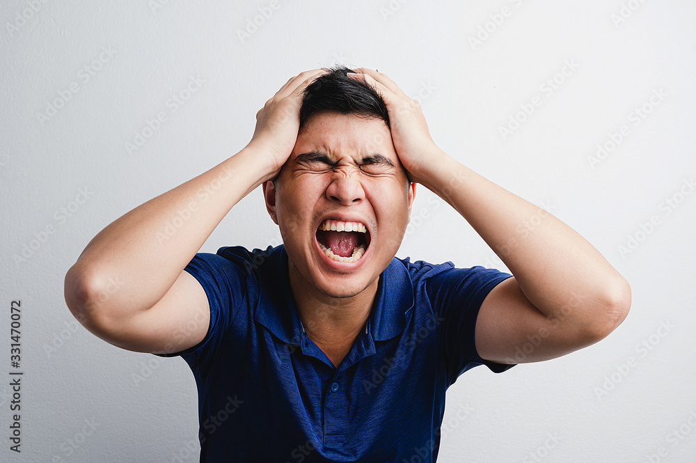 Man use his hand hold his head and shout scream with pity, angry, disappointed, frustration from mistake failure in white background. Bad situation, accident, bankrupt concept. Man use his hand hold his head and shout scream with pity, angry, disappointed, frustration from mistake failure in white background. Bad situation, accident, bankrupt concept.