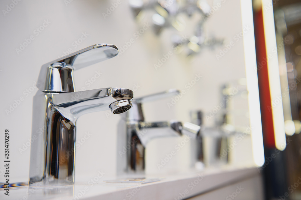 showcase in the store with faucets for the kitchen and bathroom showcase in the store with faucets for the kitchen and bathroom