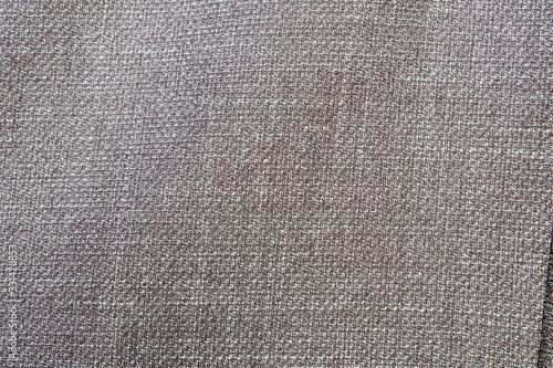 Selective focus, Close up shot of dark grey formal suit cloth textile surface. wool fabric texture for important luxury evening or night event. Wallpaper and background with copy space for text