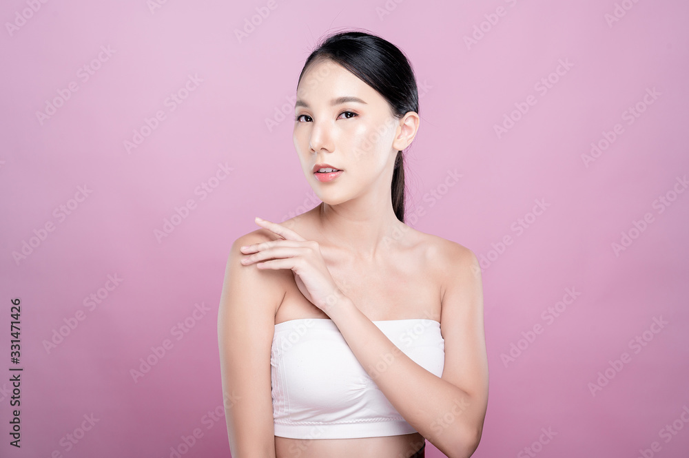 Asian woman poses for healthy skin beauty in pink seamless background. Cosmetic, skincare, surgery concept with copy space. Her skin and face are healthy, beautiful, fresh and youthful. Asian woman poses for healthy skin beauty in pink seamless background. Cosmetic, skincare, surgery concept with copy space. Her skin and face are healthy, beautiful, fresh and youthful.