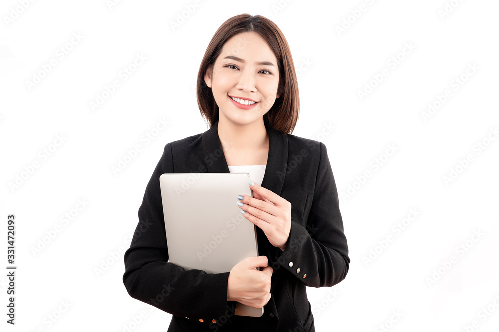 Asian businesswoman with black suit holding a laptop with big smile beaming face in white isolated background. Asian businesswoman with black suit holding a laptop with big smile beaming face in white isolated background.