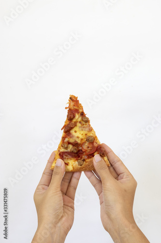 Slice of fresh  classic original Pizza held by hand © Daniel Ferryanto