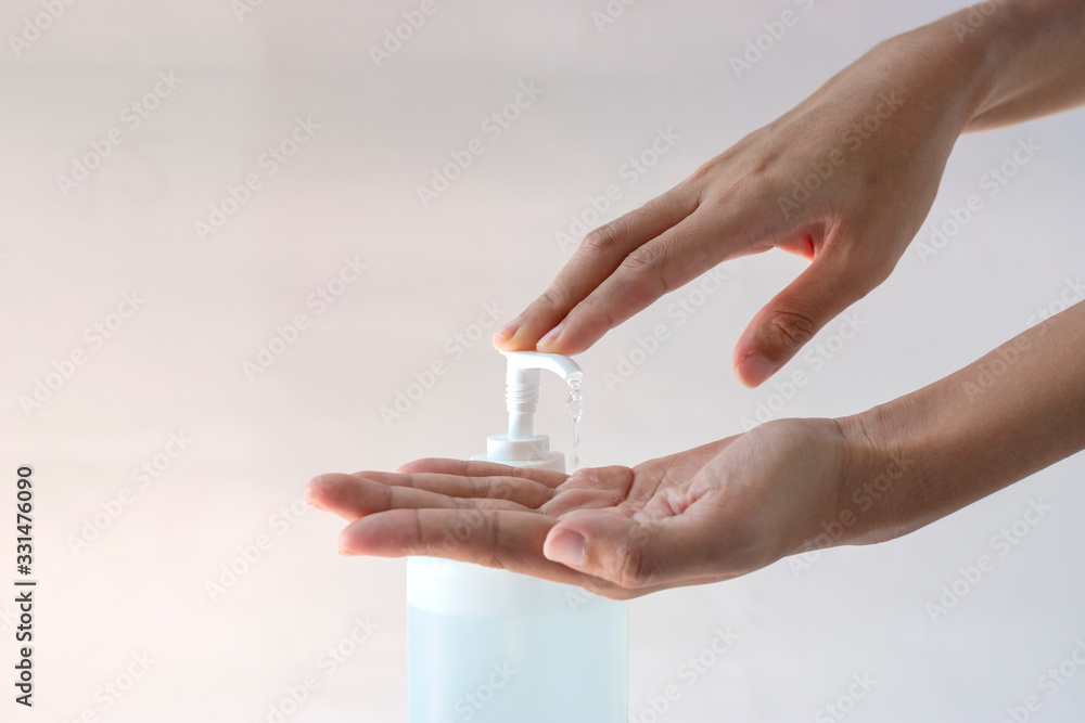 Plakat Asian women washing hands with alcohol sanitizer. Hygiene concept. prevent the spread of germs and bacteria and avoid infections corona virus Covid - 19