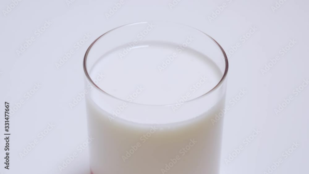 Glass cup with homemade yogurt isolated on white background. The glass cup stands motionless Glass cup with homemade yogurt isolated on white background. The glass cup stands motionless