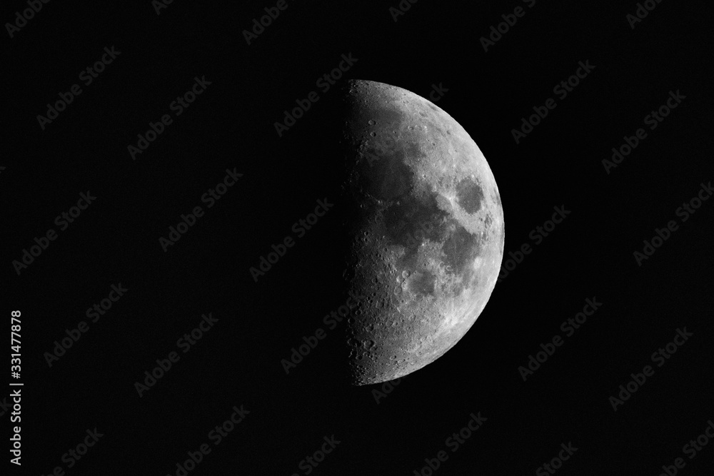 A black and white crescent moon in front of a black background without stars A black and white crescent moon in front of a black background without stars