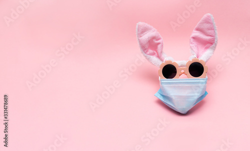 easter bunny in protective medical masks quarantine concept for easter holida...