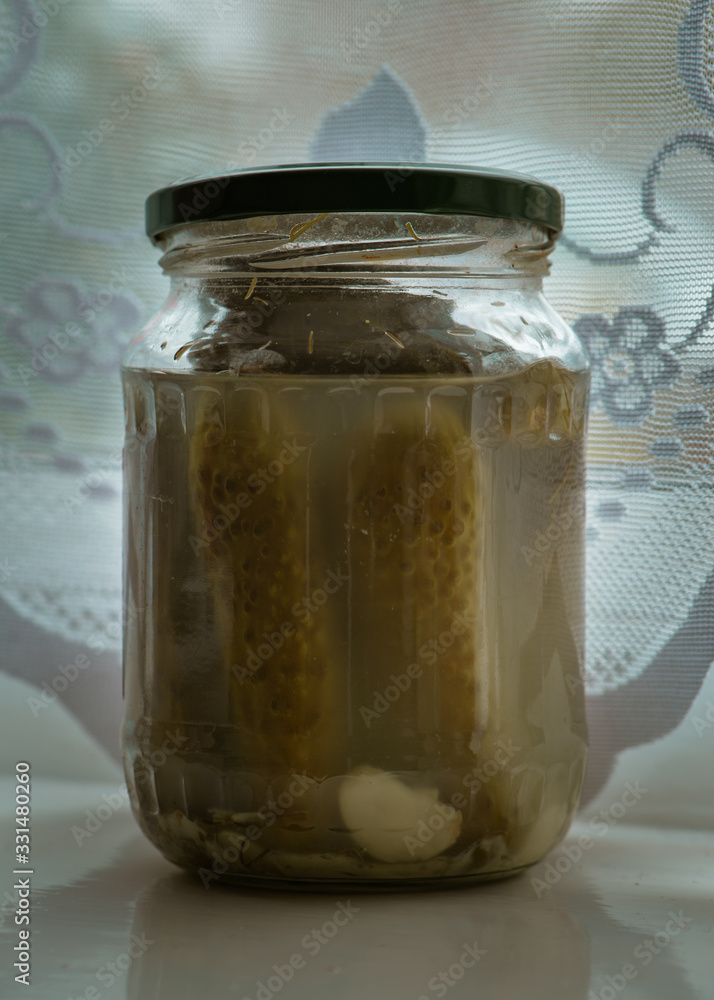 Pickled cucumbers in a glass jar. Pickled cucumbers in a glass jar.