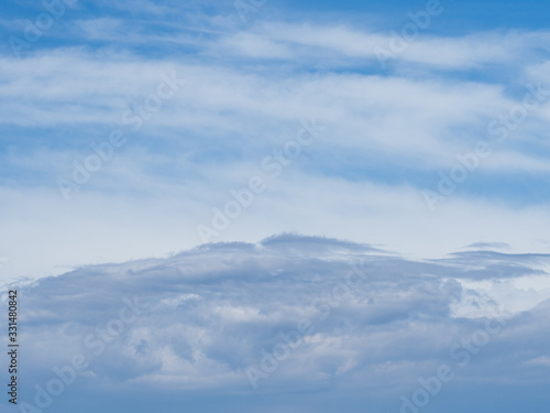 Airy skyscape of blue sky with white clouds. © Elena