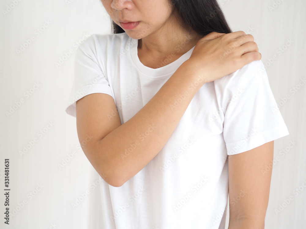 spondylosis and degenerative disc disease in asian woman and she touching her shoulder symptoms of pain and suffering on white background use for health care concept. spondylosis and degenerative disc disease in asian woman and she touching her shoulder symptoms of pain and suffering on white background use for health care concept.