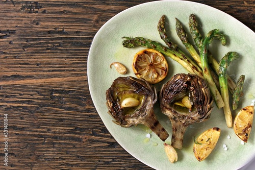  artichoke and asparagus grill. Tasty vegetables are first cooked for a couple, then fried on a grill, poured with olive oil and spices. spring vegetables. Flatlay.  copy space. top view
