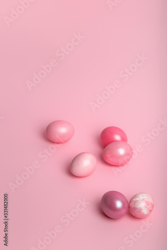 Pink colored eggs on a pink background.