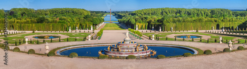 Panoramic view of the Versailles Park - the Latona Basin with the Grand Canal in the background under the summer sun, Versailles, France photo