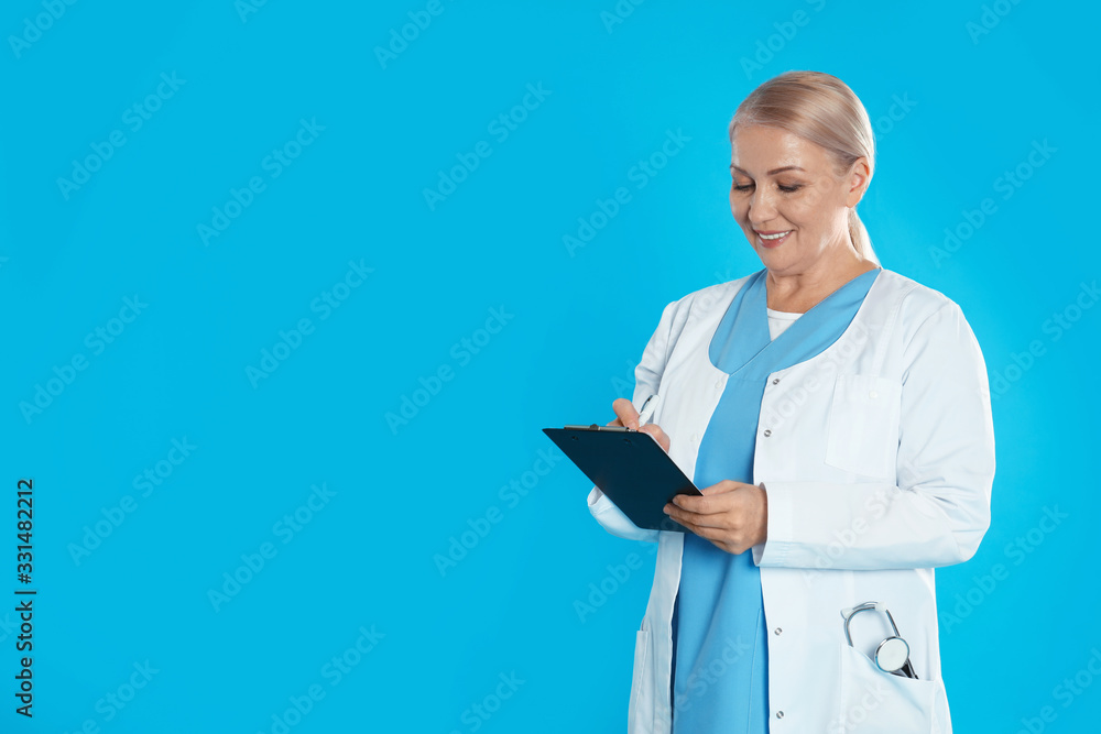 Mature doctor with clipboard on blue background. Space for text Mature doctor with clipboard on blue background. Space for text