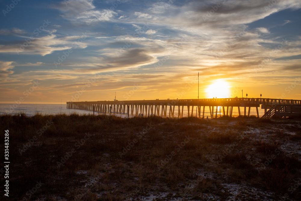 panama city beach florida ocean at shoreline with beautiul sunset clouds and pier into the water panama city beach florida ocean at shoreline with beautiul sunset clouds and pier into the water