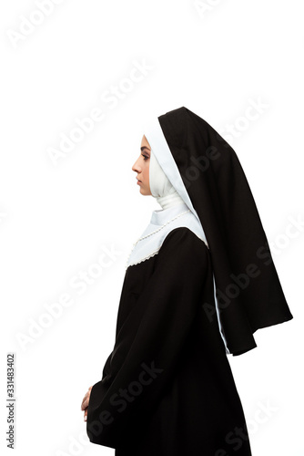 Obraz na plátně side view of nun in black clothing, isolated on white