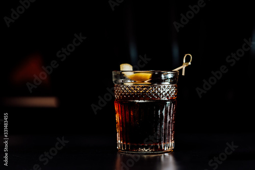 cocktail in a dark key, on a dark background, with different metal details