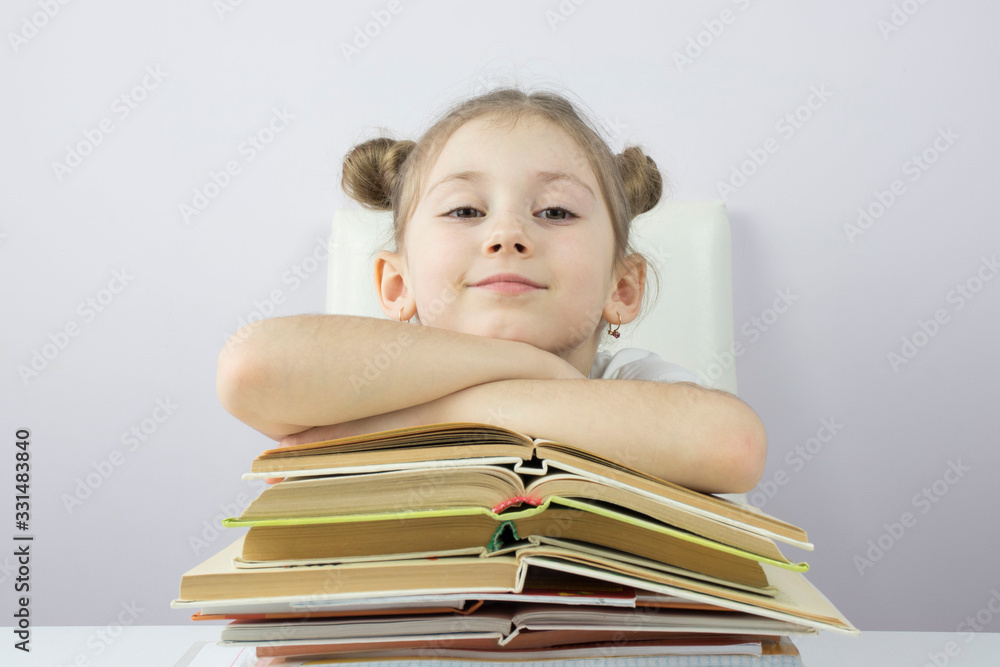beautiful Caucasian little girl with a stack of books, education concept beautiful Caucasian little girl with a stack of books, education concept