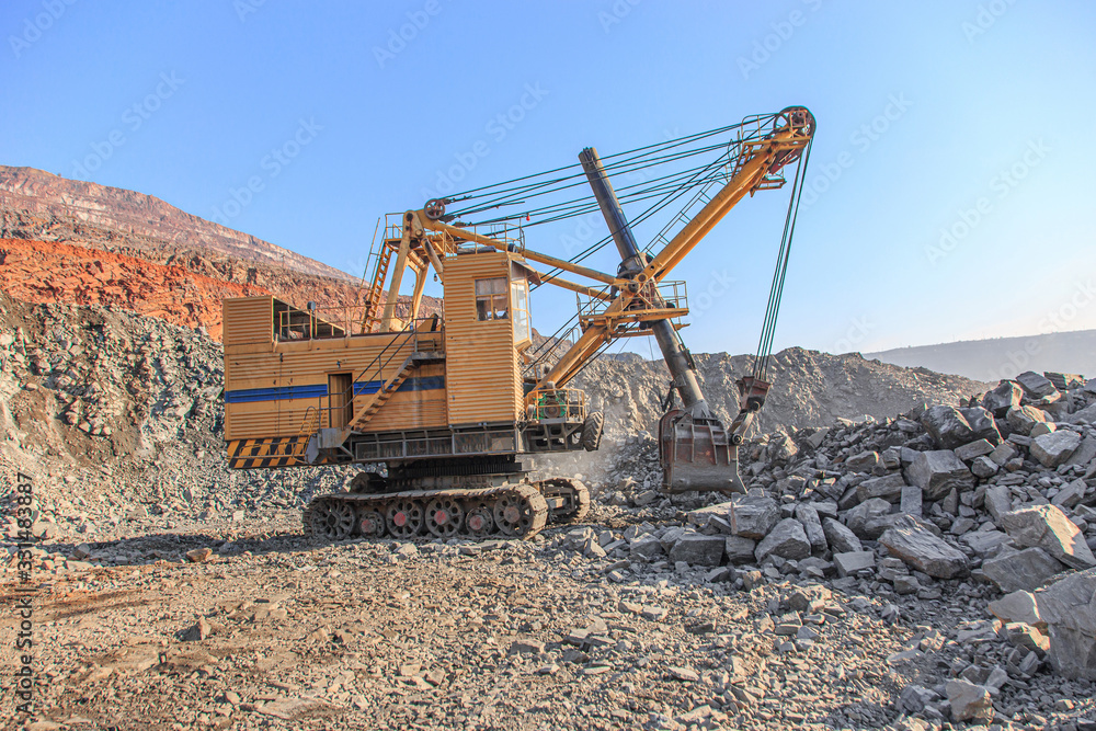 Old big mining excavator in an iron ore quarry Old big mining excavator in an iron ore quarry