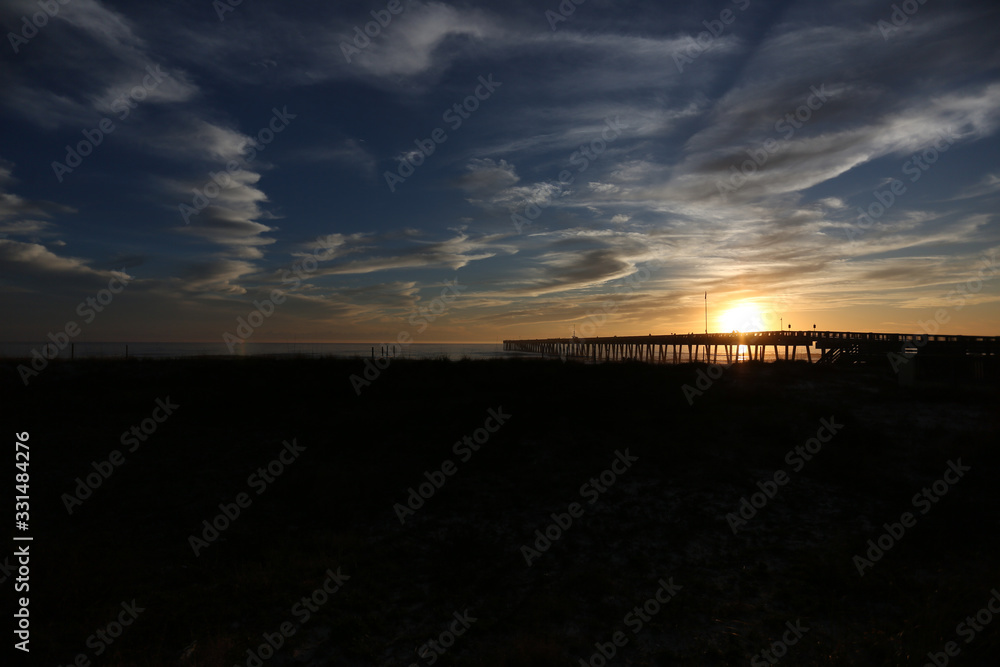 sundown at panama city beach pier with silhouette beach and pier and sunset clouds and sky sundown at panama city beach pier with silhouette beach and pier and sunset clouds and sky