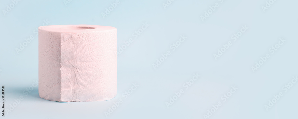 Obraz premium Toilet roll on blue background. Concept of lack of toilet paper in stores due to coronavirus, Covid-19, hygiene, panic. Copy space, deficit of sanitary set in supermarket