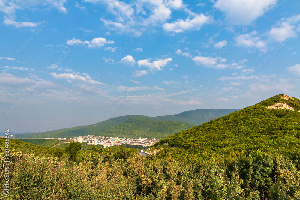 Naklejka premium Background, old mountains, gorge city, blue sky.