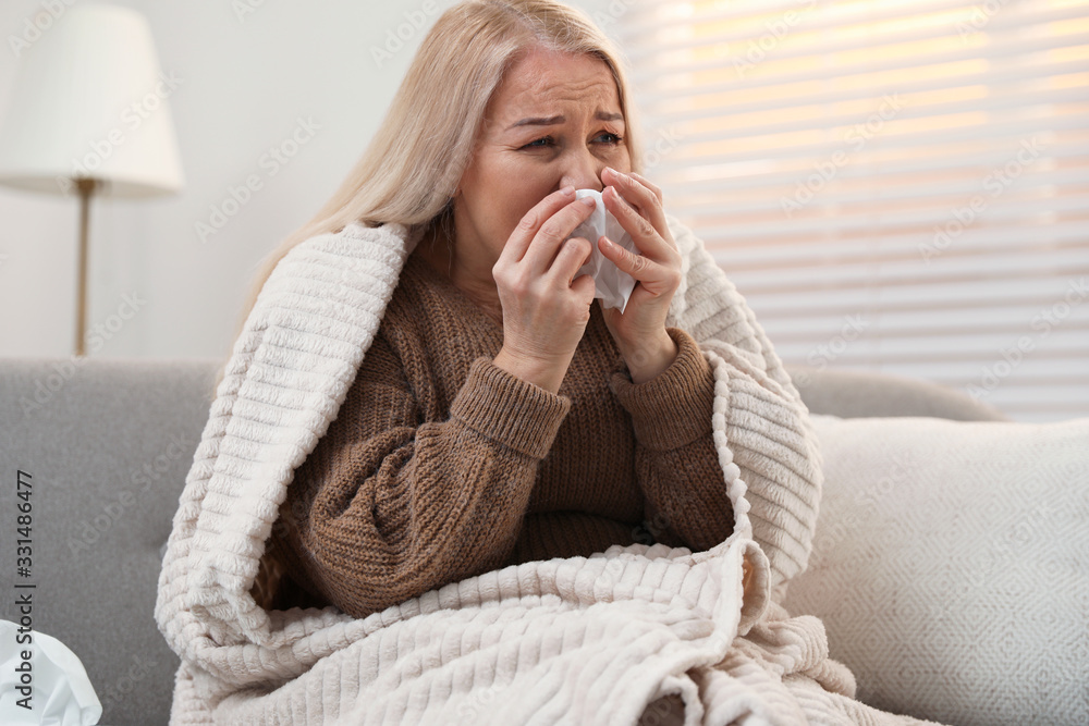 Mature woman suffering from cold at home. Dangerous virus Mature woman suffering from cold at home. Dangerous virus